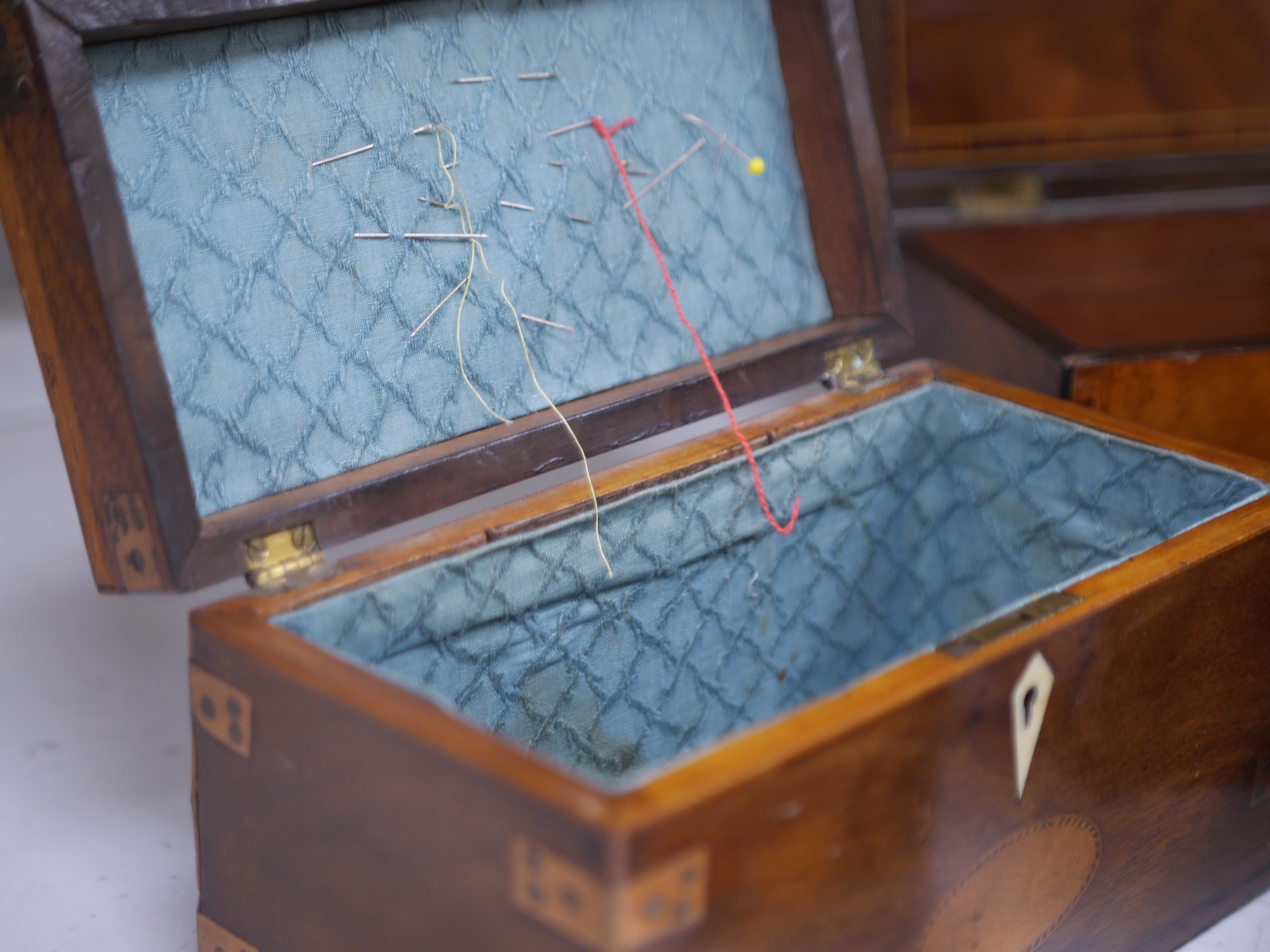 An early 19th century inlaid tea caddy, two sewing boxes and a stationery box, 25.5cm x 14cm various. Condition - stationery box good, others have some damage